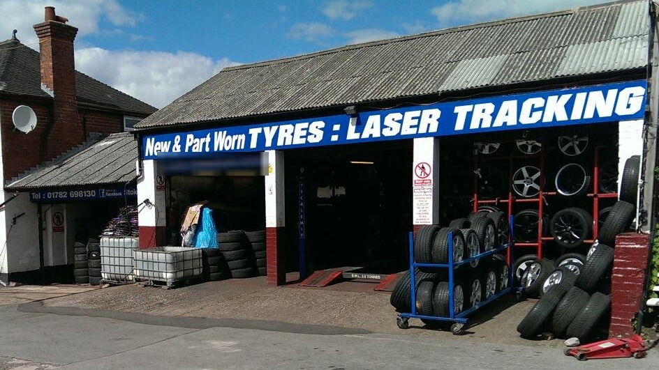 The Stoke Tyres frontage on Leek Road on a sunny day, with tyres and alloy wheels racked outside the bays